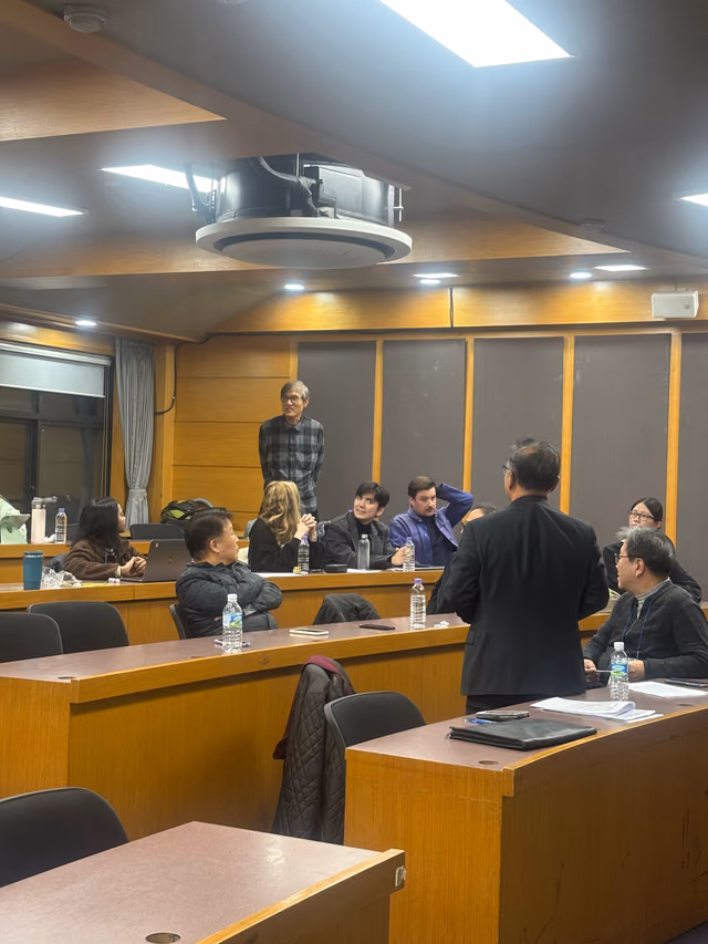 Members seated at the tiered desks of the lecture hall during the founding assembly